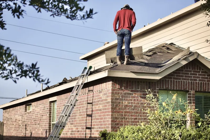 Professional roofer working on a residential roof in North Buckhead